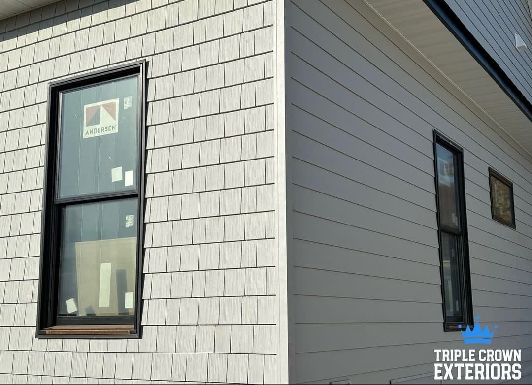 Modern home exterior showcasing Andersen windows and textured paneling by Triple Crown Exteriors.