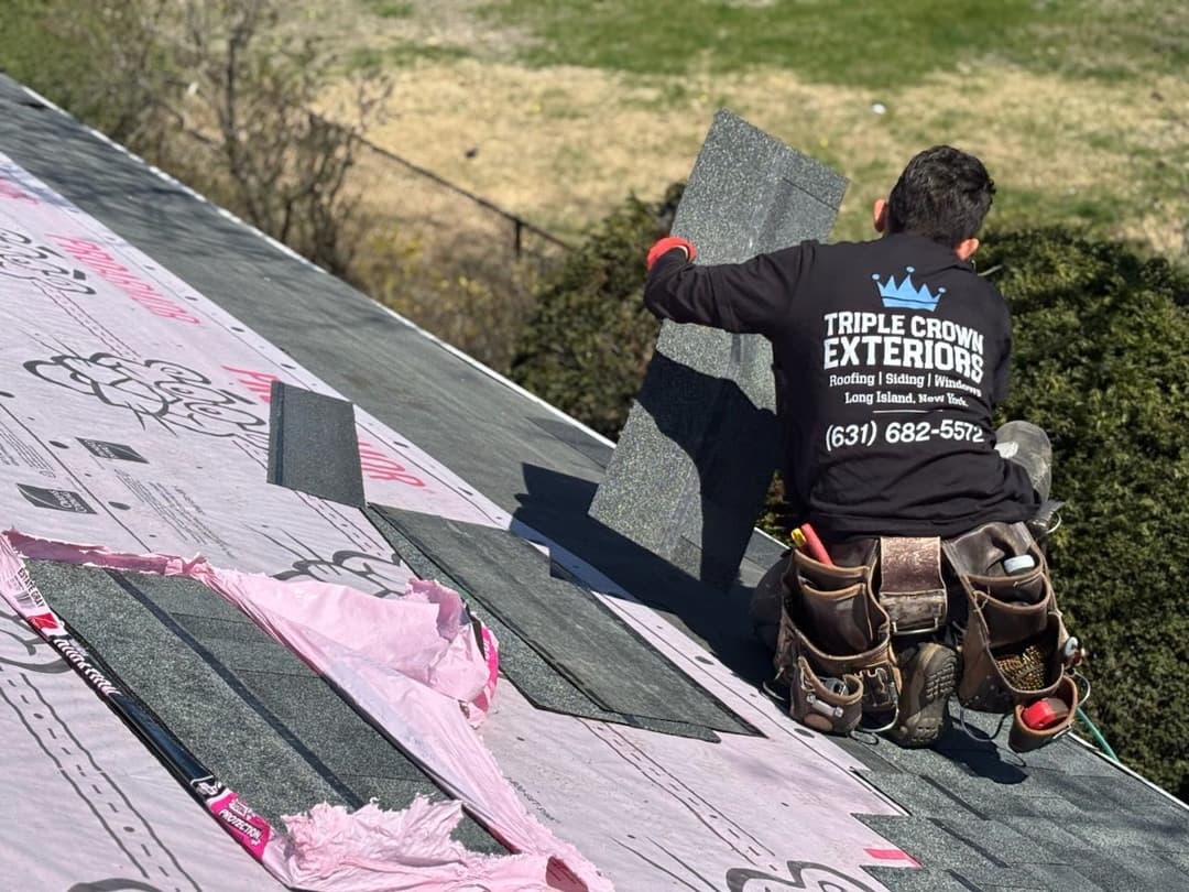 Roofer installing shingles on a residential roof, Triple Crown Exteriors, Long Island.