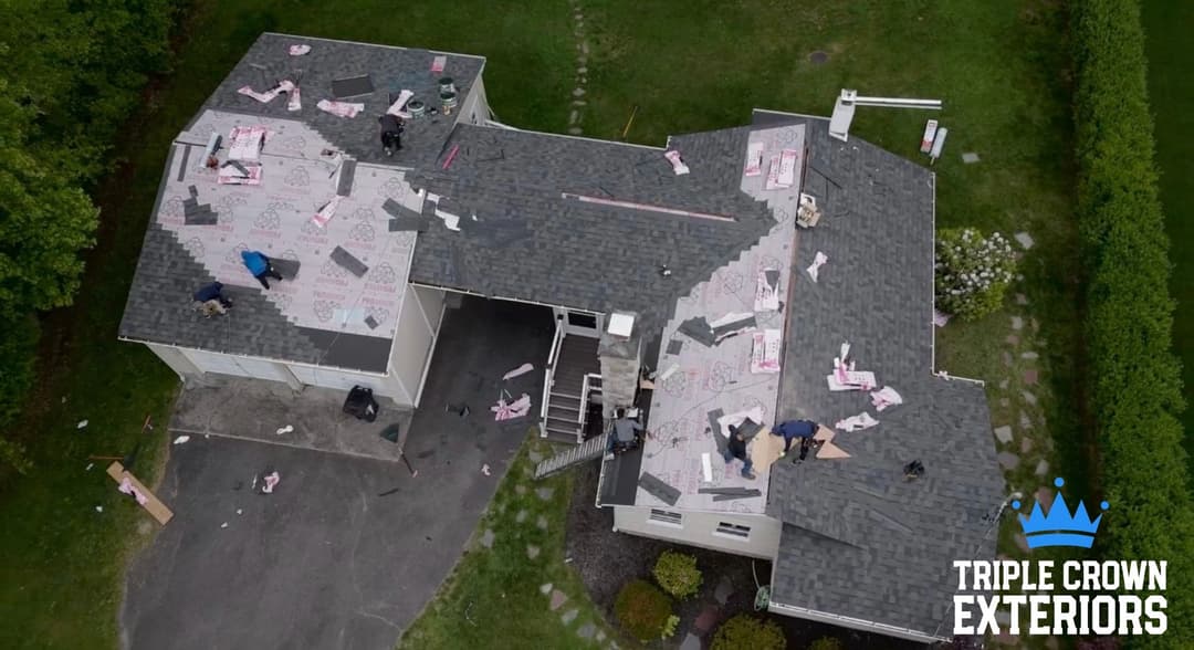 Roofing installation in progress on a residential home by Triple Crown Exteriors.